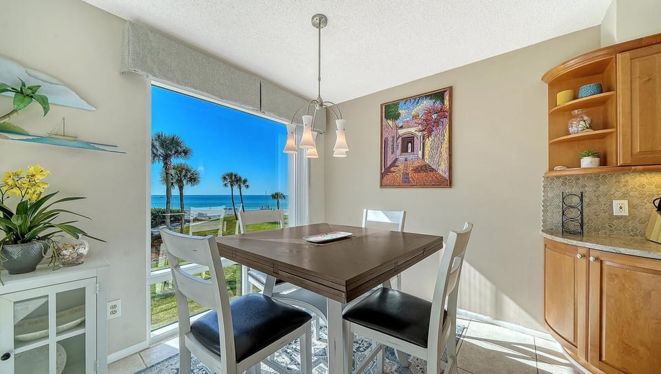 Sunlit dining area with ocean views and coastal charm