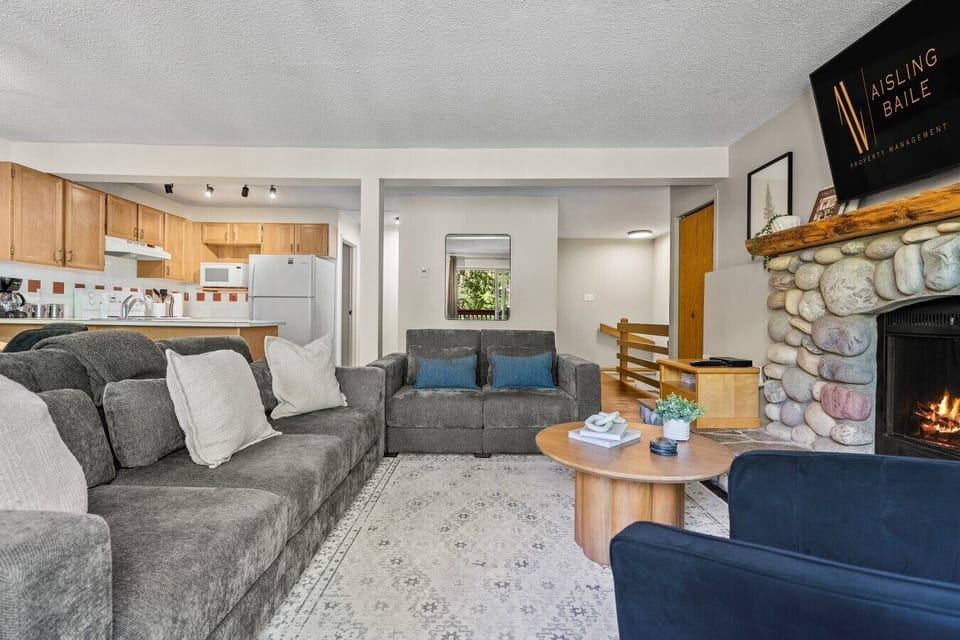 Main floor living room with a Smart TV with cable, board games, cozy seating options, and a decorative fireplace (fireplace can not be used).