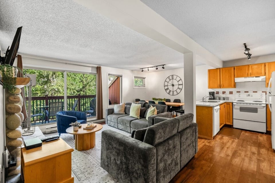 Main floor living room with a Smart TV with cable, board games, cozy seating options, and a decorative fireplace (fireplace can not be used).