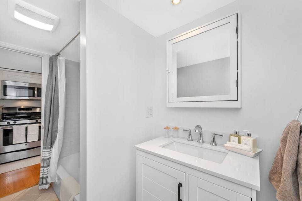 Updated bathroom with a full-size tub and shower. Shampoo, conditioner, and body wash provided.