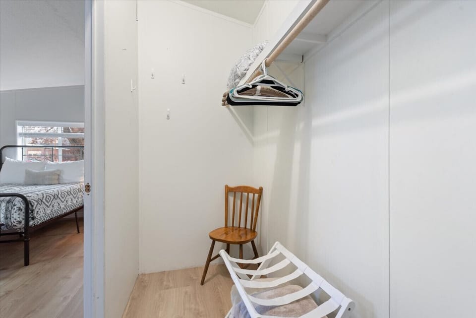 Master closet with ample space for clothing storage and a luggage rack