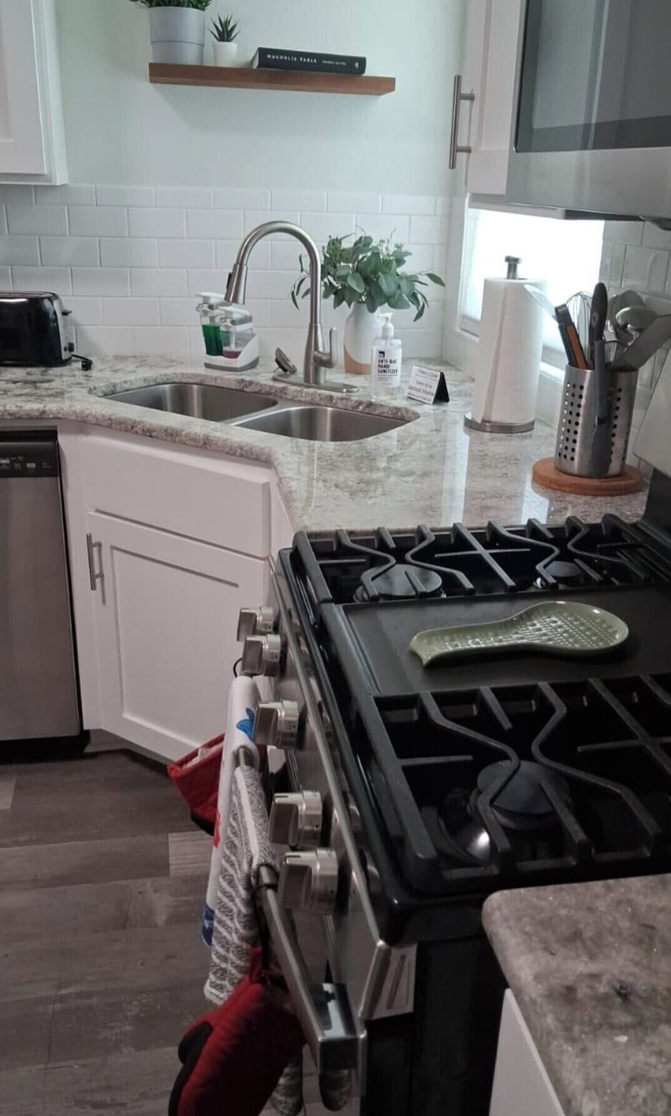 Bright modern kitchen with gas range, double sink, and stylish finishes
