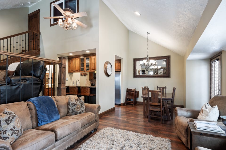 Warm and spacious main living area featuring comfortable seating, dining space, and large windows that fill the room with natural light.