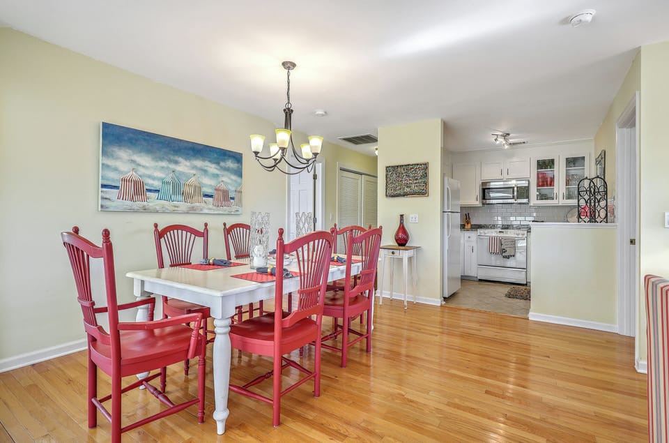 Enjoy a seamless flow from the fully equipped kitchen to your colorful, coastal dining table.
