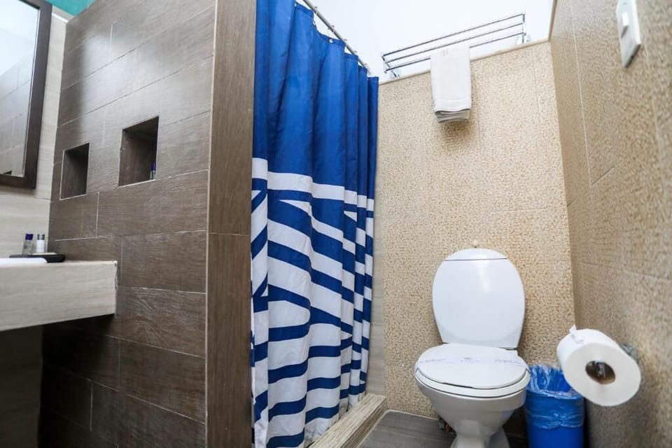 Refresh in a clean bathroom with shower and fresh towels.
