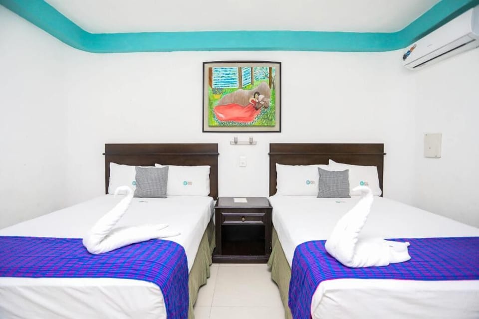 Sink into plush beds beneath colorful art and cool air.