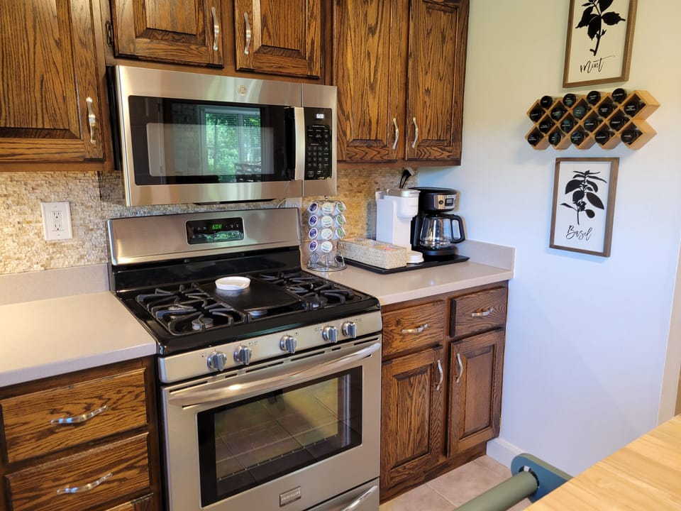 The coffee station is well stocked with everything you need to make a hot drink.