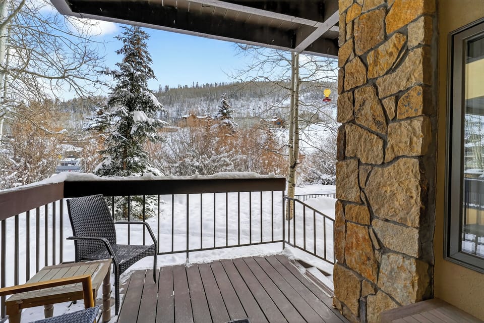 Private covered balcony with peaceful winter views—perfect for morning coffee or après-ski downtime.