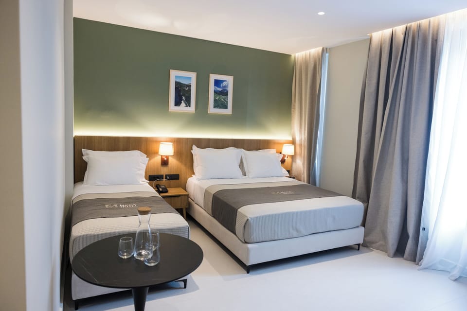 Superior Triple Room | Minibar, in-room safe, desk, blackout drapes