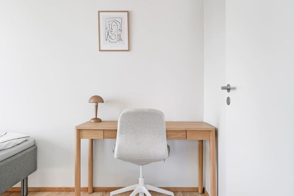 A bright and quiet workspace with a comfortable chair and spacious desk, perfect for guests who need to catch up on work or enjoy a focused study session during their stay.