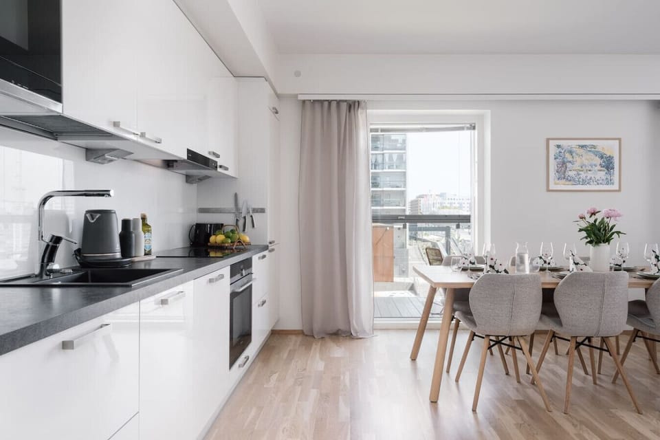 Modern and fully equipped kitchen and dining area with large windows offering light as well as direct access to the balcony to enjoy your treats there.