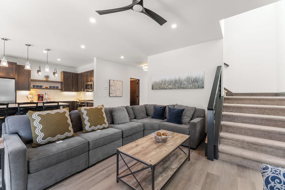 Living area with a remote control gas fireplace, mounted TV, and access to the hot tub patio.