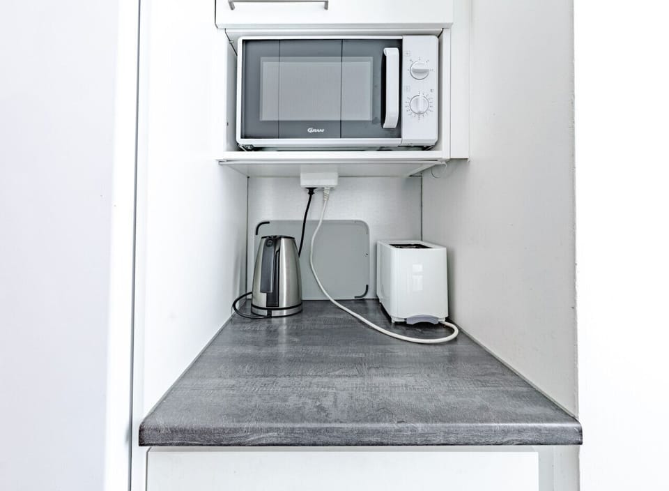 Small appliances like a microwave, kettle, and toaster are readily available to make your morning breakfast routine quick and easy.