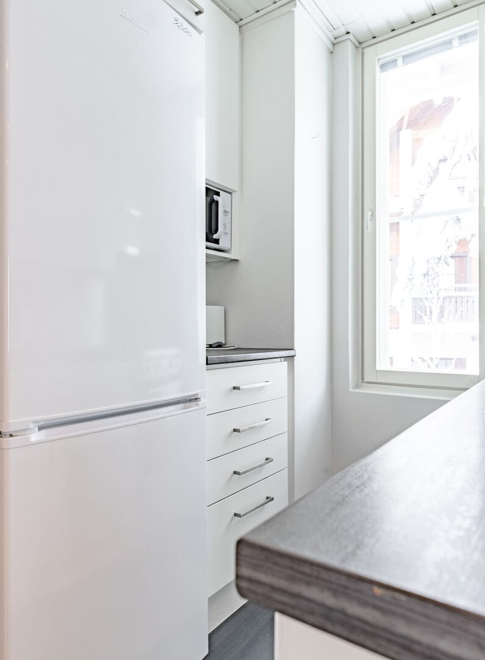The compact kitchen is efficiently organized and includes a full-sized refrigerator to store all your groceries for a longer stay.