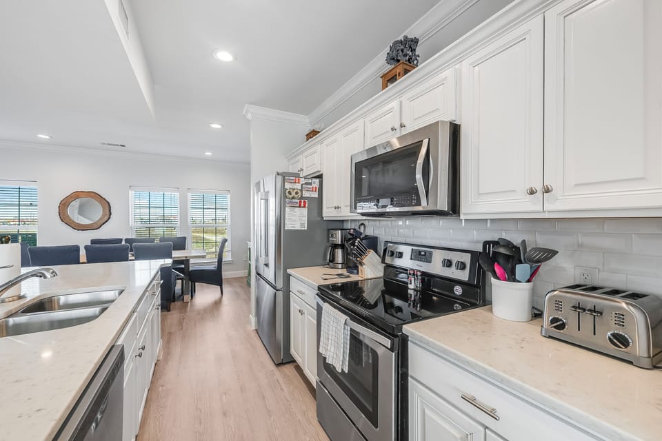 Your fully equipped kitchen awaits with sleek appliances, granite counters, and everything needed to create memorable meals during your stay.