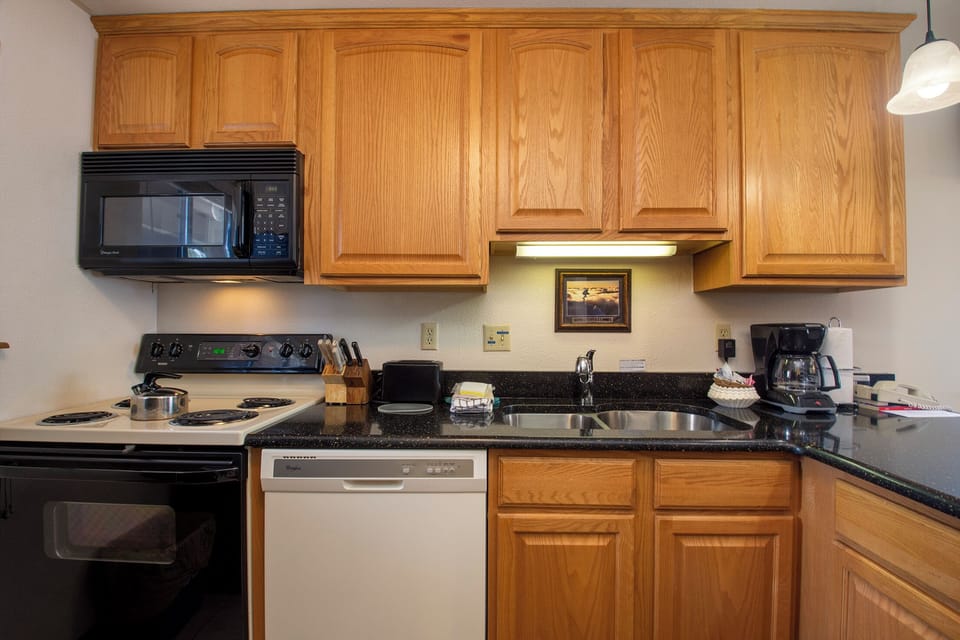 Your fully equipped kitchen features warm oak cabinets, granite countertops, and everything needed to prepare memorable meals during your stay.