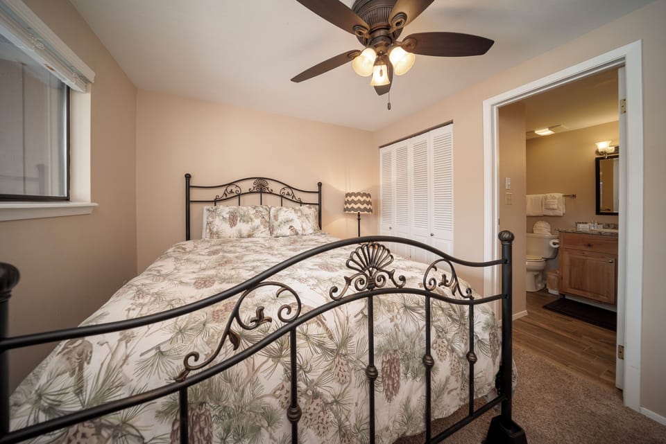 Unwind in your private bedroom with elegant iron bed frame, soft linens, and convenient ensuite bathroom access for ultimate comfort.