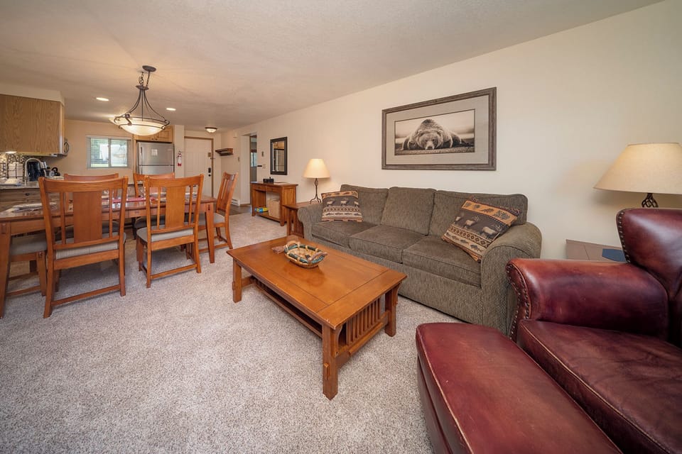 Unwind in your spacious living area with comfortable seating and warm wood furnishings that create the perfect mountain retreat atmosphere.