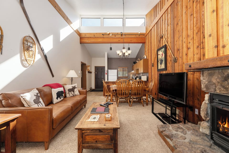 Cozy up in your mountain retreat with warm wood accents, crackling fireplace, and soaring ceilings that create the perfect alpine atmosphere.