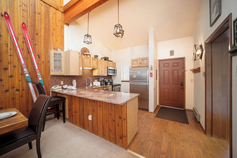 Your cozy mountain kitchen welcomes you with rustic wood details and modern granite counters, perfect for preparing hearty meals after a day on the slopes.