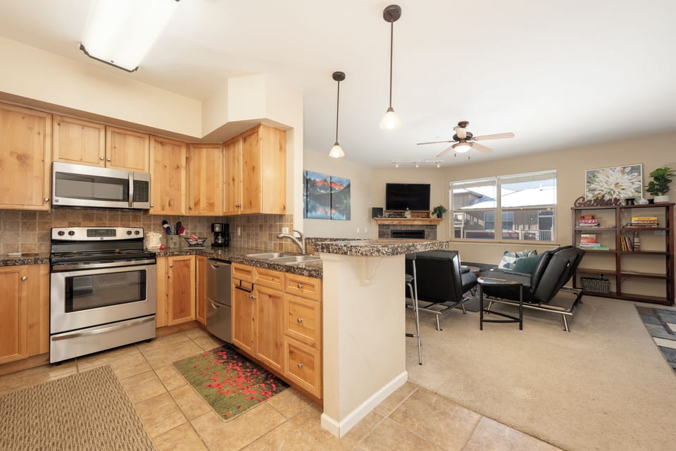 Your open-concept retreat seamlessly blends modern kitchen convenience with cozy living space for memorable gatherings and relaxing evenings.