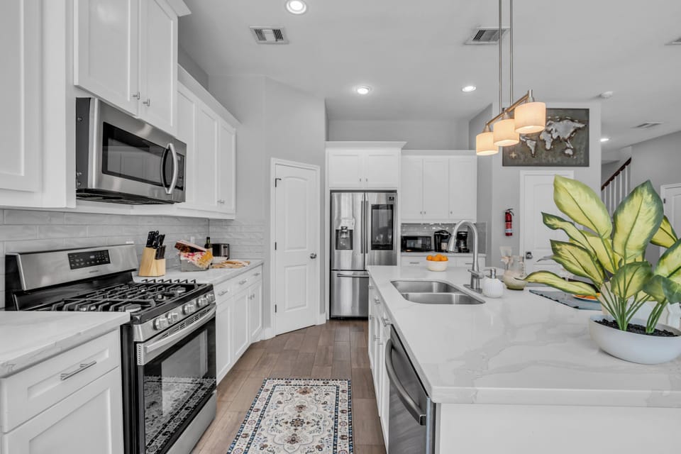 Fully equipped kitchen with stainless appliances and ample counter space.