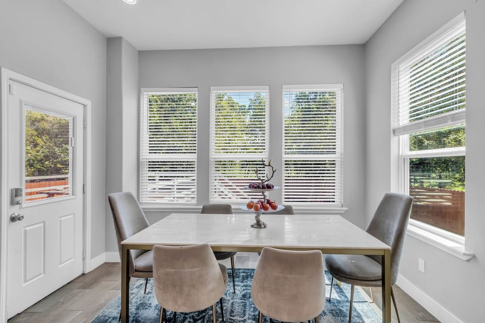 Six-chair dining by the deck with peaceful wooded backyard views to enjoy!