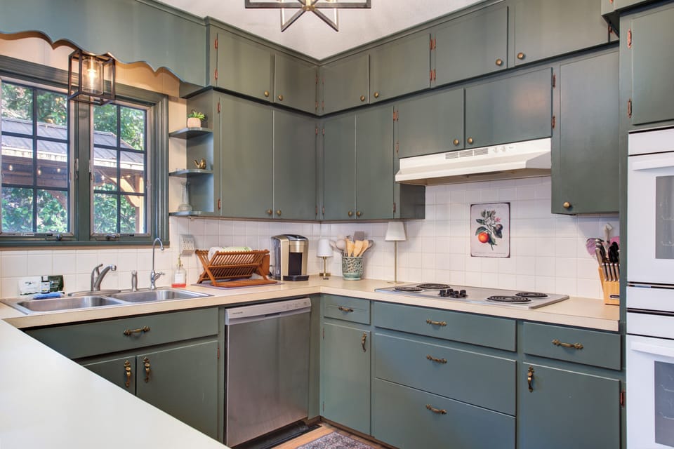 Your fully equipped kitchen features sage-green cabinets, modern appliances, and everything you need to create memorable meals during your stay.