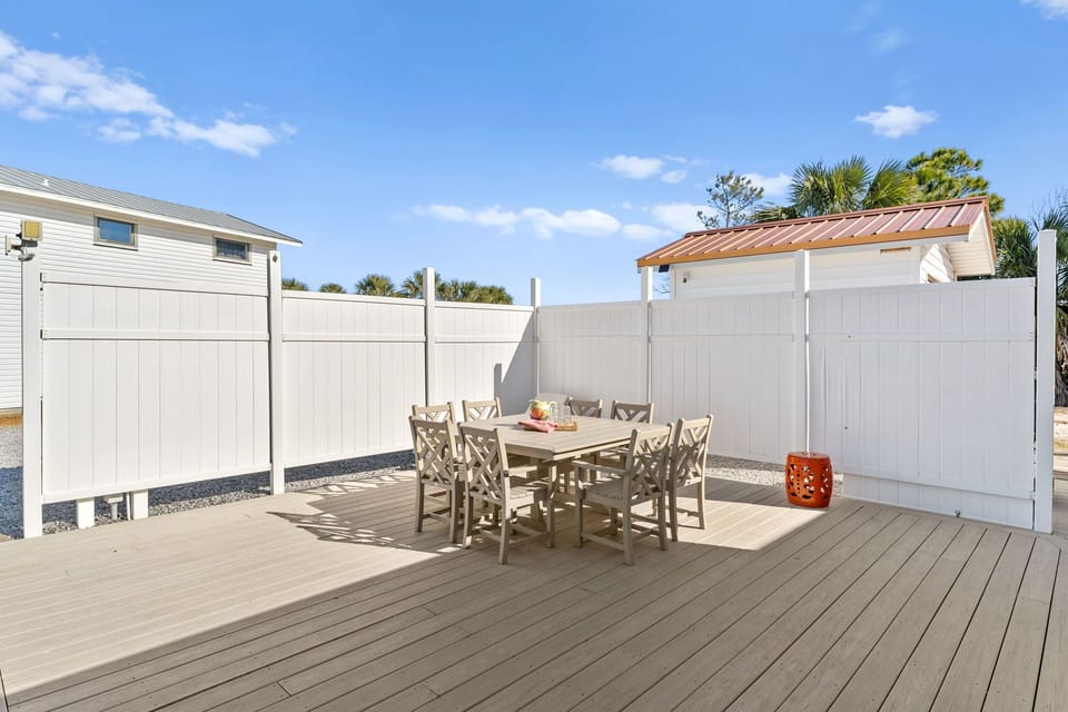 Your private deck awaits with comfortable seating for eight, perfect for morning coffee or sunset dinners in complete privacy.