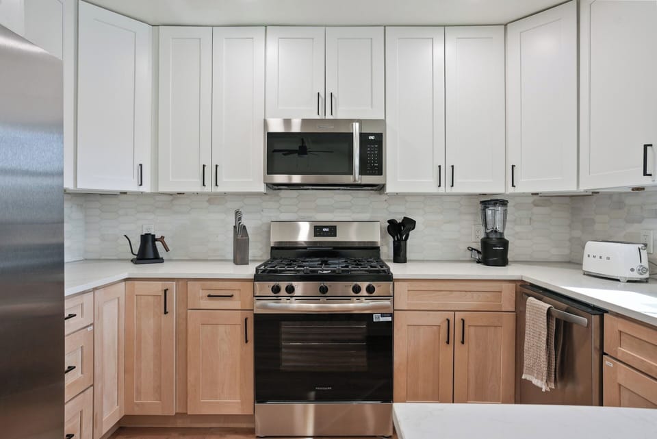 Brand new appliances - coffee station next to fridge.
