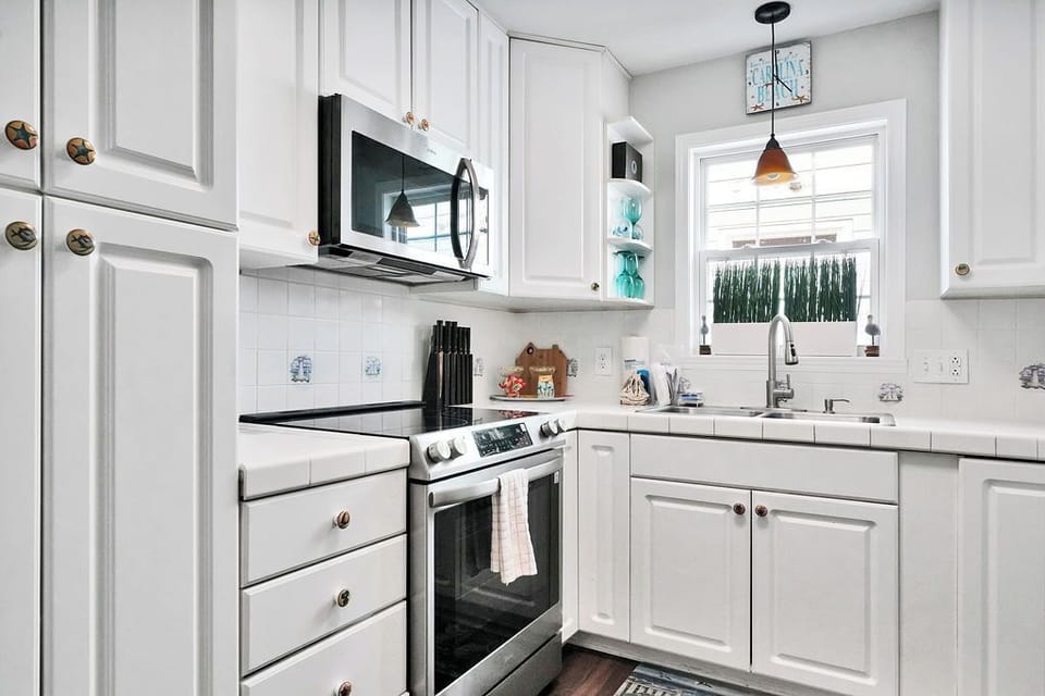 Your bright, fully-equipped kitchen awaits with modern appliances and charming garden views to inspire your home-cooked meals.