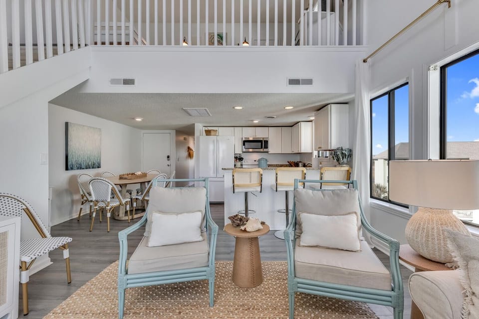 Your spacious retreat flows seamlessly from kitchen to living room, with bright windows flooding the space in natural light.