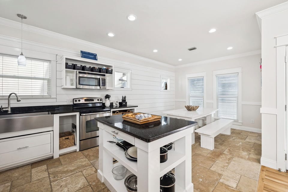 Your bright, modern kitchen awaits with granite counters, stainless appliances, and a convenient island for meal prep.