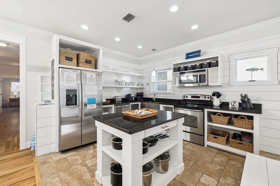 Your gourmet kitchen awaits with granite countertops, stainless steel appliances, and charming coastal touches that make meal prep a joy.