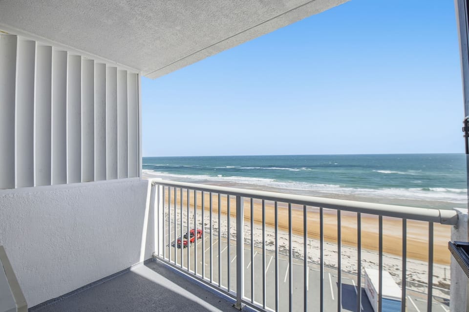 Enjoy breathtaking views of the cerulean waves and golden sands from your private balcony, perfect for soaking in the sun and listening to the soothing sounds of the ocean.