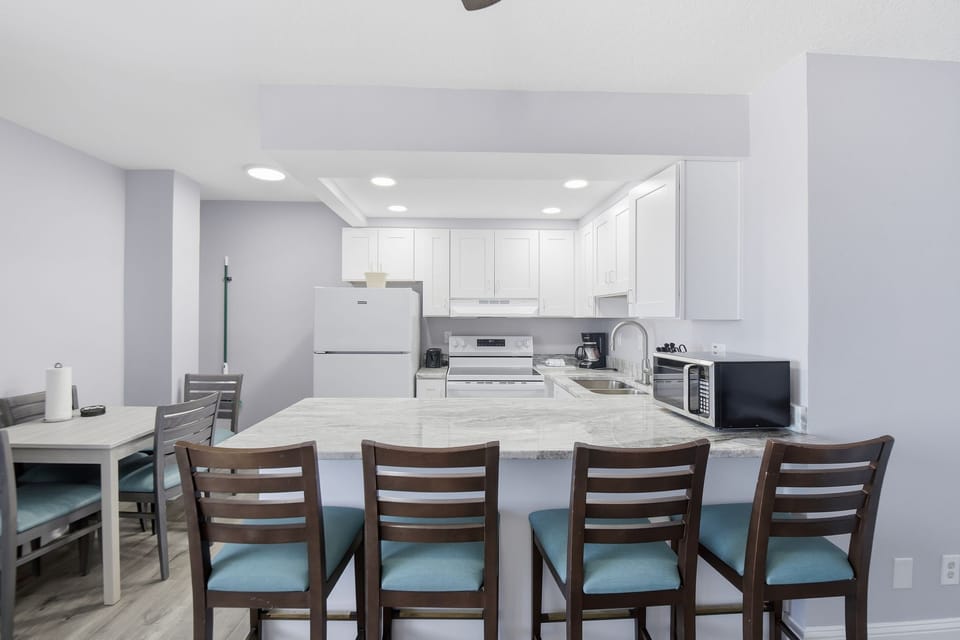 Gather around the charming dining area, where elegant simplicity meets beach vibes, making every meal a delightful experience with ocean views to inspire.