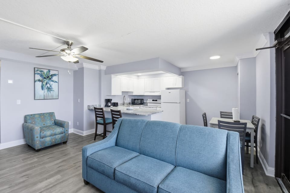 The airy living room invites cozy gatherings, showcasing a chic sofa, contemporary furnishings, and front-row ocean views that make every moment feel special.