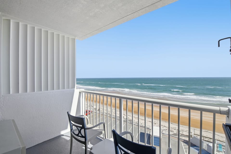 Enjoy stunning ocean views from the private balcony, furnished with comfortable chairs, creating an ideal space for morning coffee or evening relaxation with the sound of waves crashing nearby.
