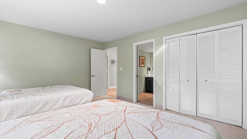 Bedroom 2 with 2 queen beds, and shared ensuite 