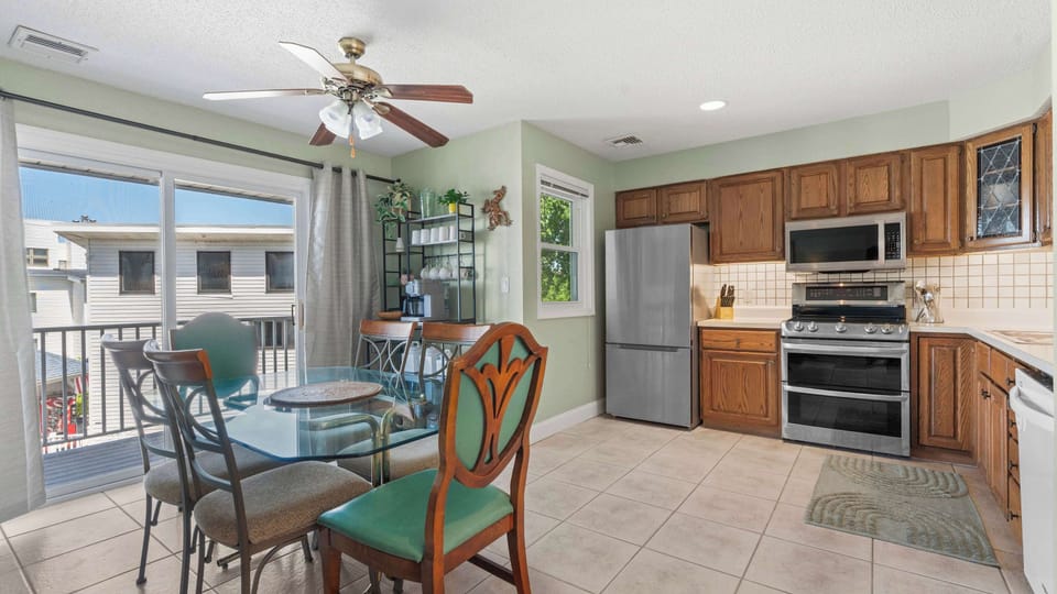 Full kitchen with dining table and deck access