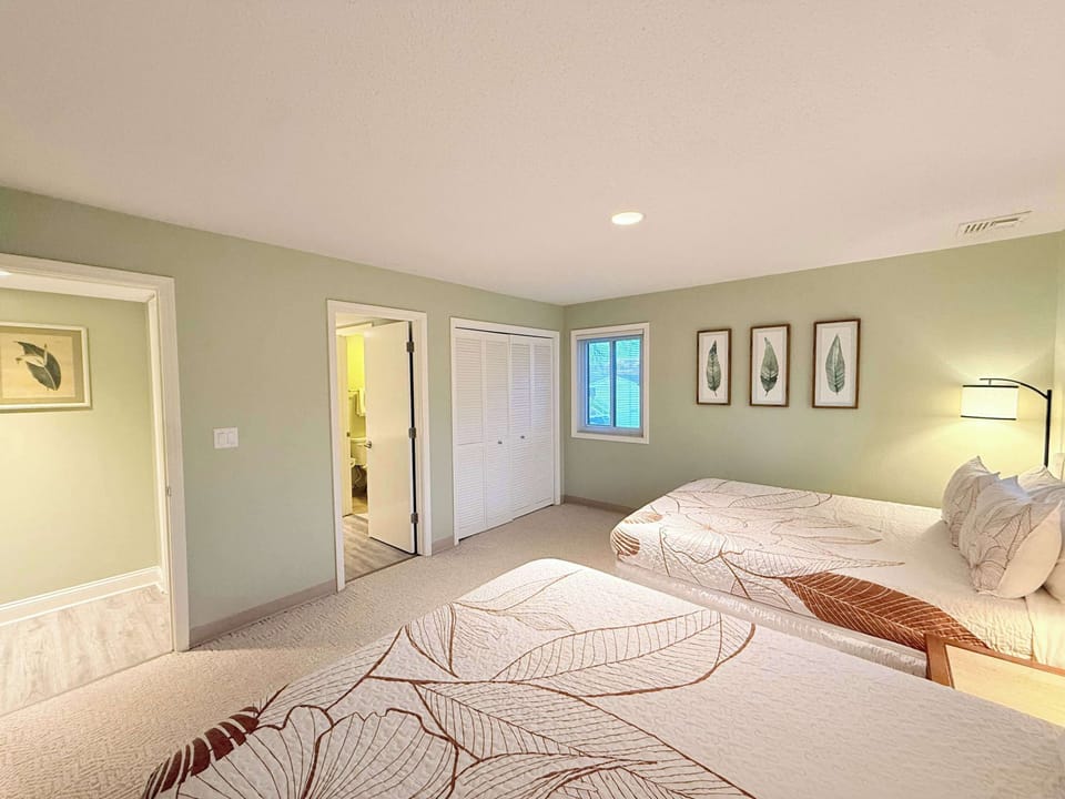 Bedroom 2 with 2 queen beds, and shared ensuite 