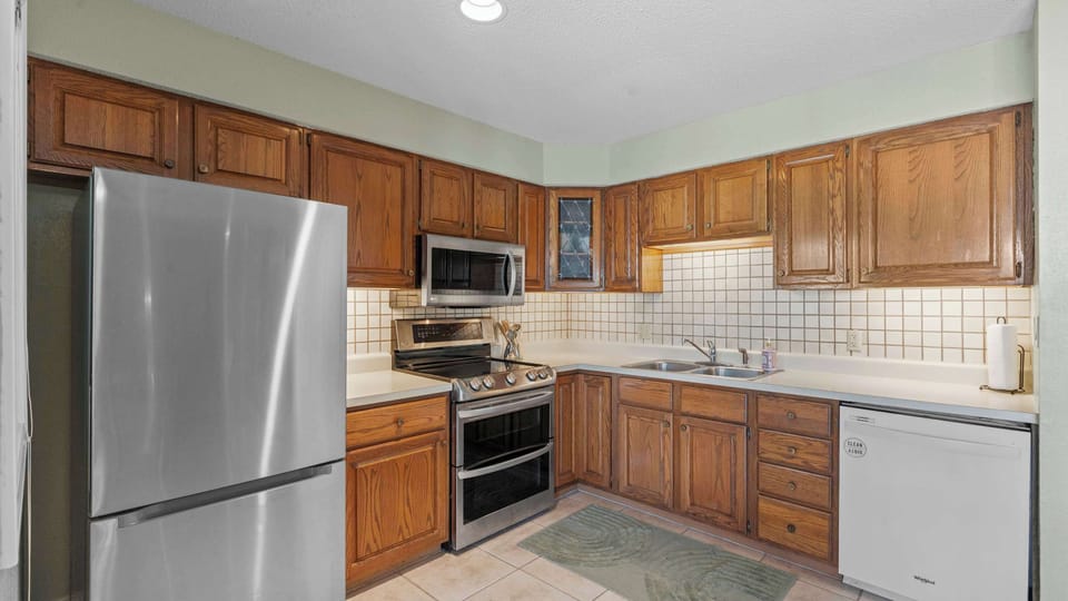 Full kitchen with dining table and deck access