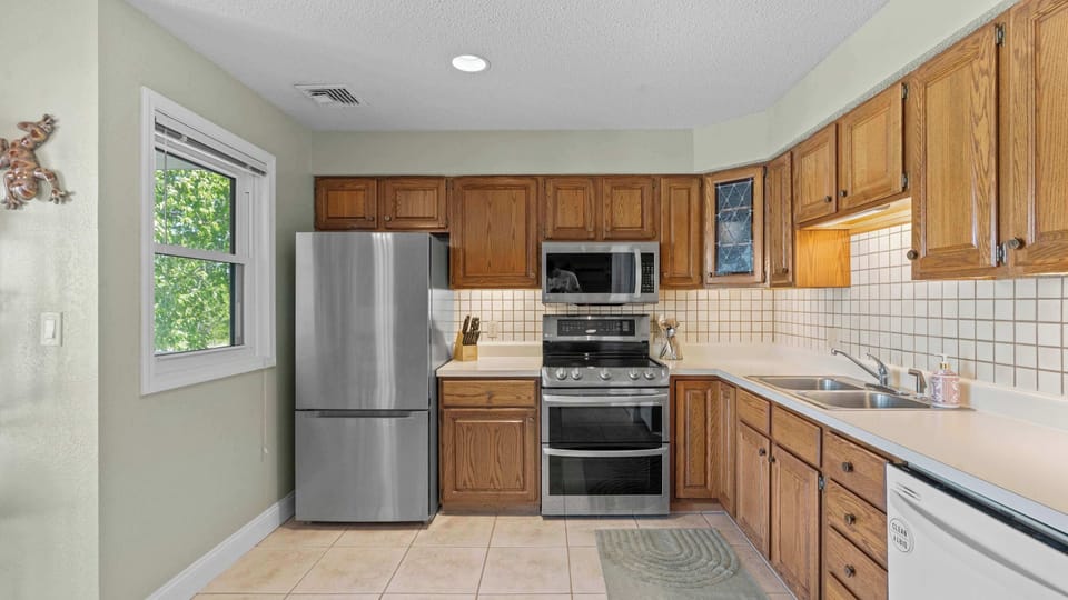 Full kitchen with dining table and deck access