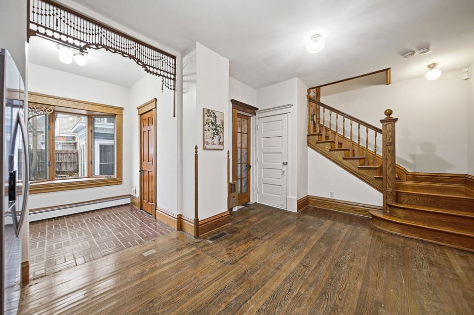 One section of the central staircase opens into the updated full kitchen