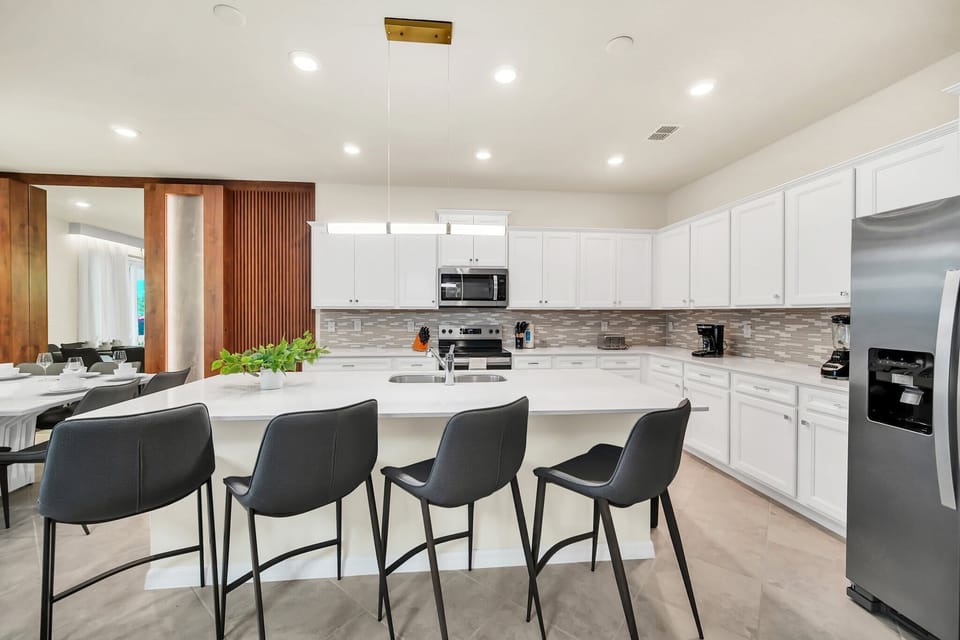 Modern kitchen with a large island and seating for five.