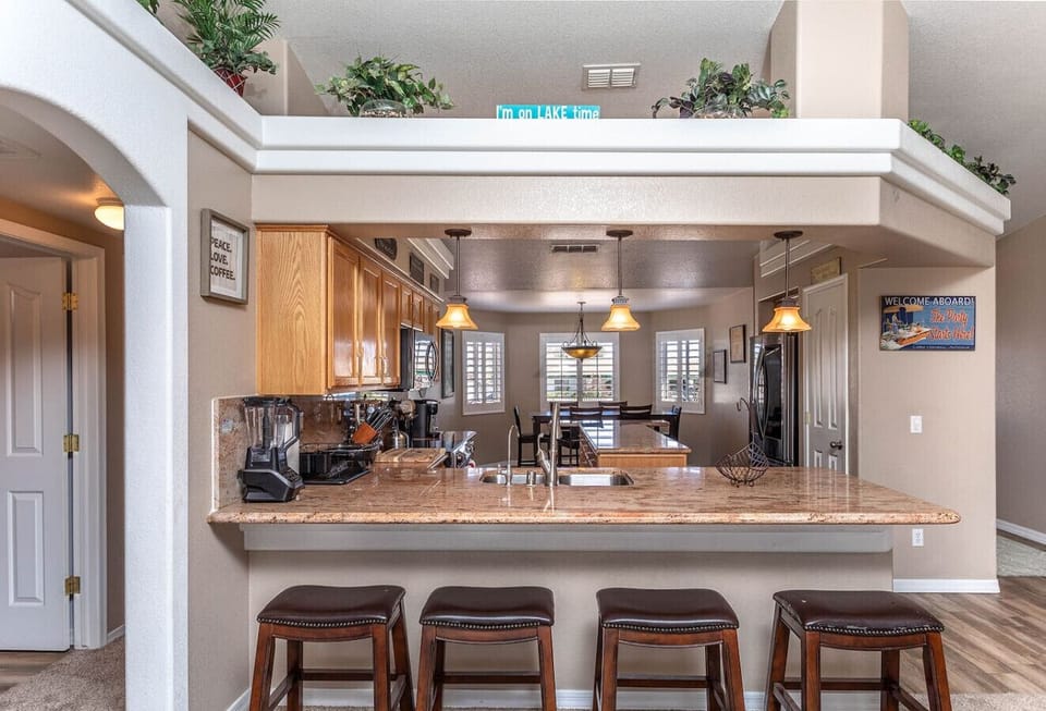 Open kitchen view with ample counter space and breakfast bar for group meals.