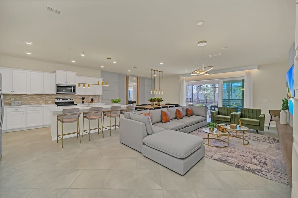Expansive open-plan living & kitchen area flooded w/ natural light & modern finishes.
