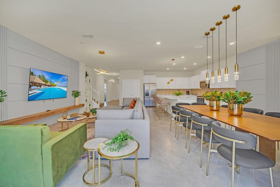 Open kitchen & living space w/ bold art & colorful seating that pops w/ personality.
