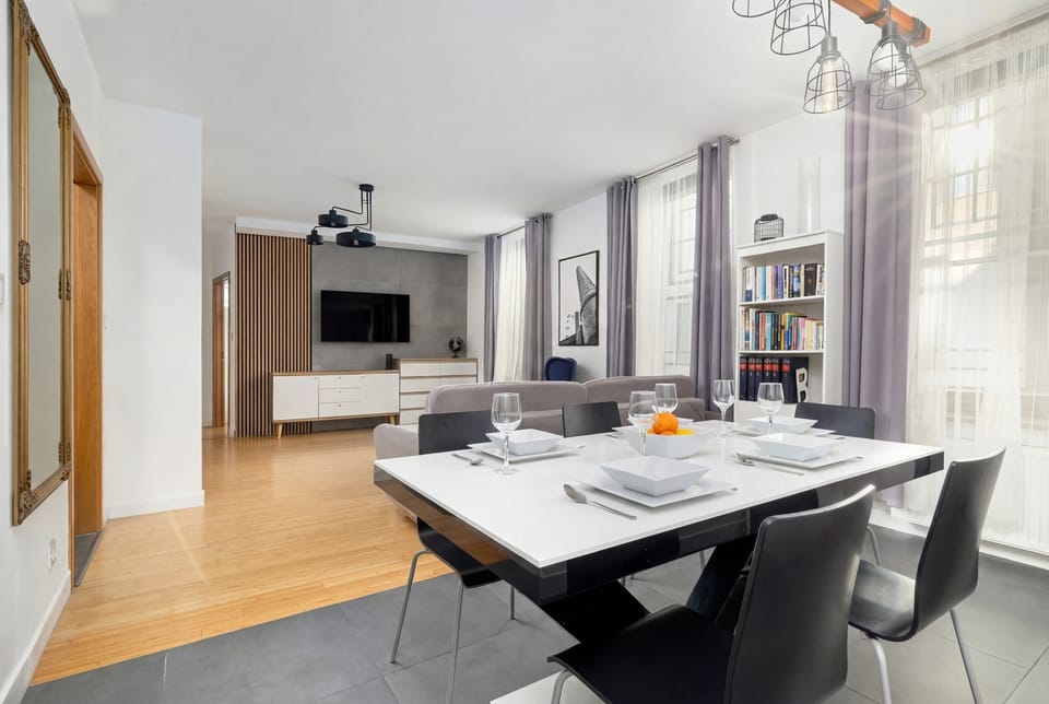 Dining table placed next to the kitchenette in an open living space.