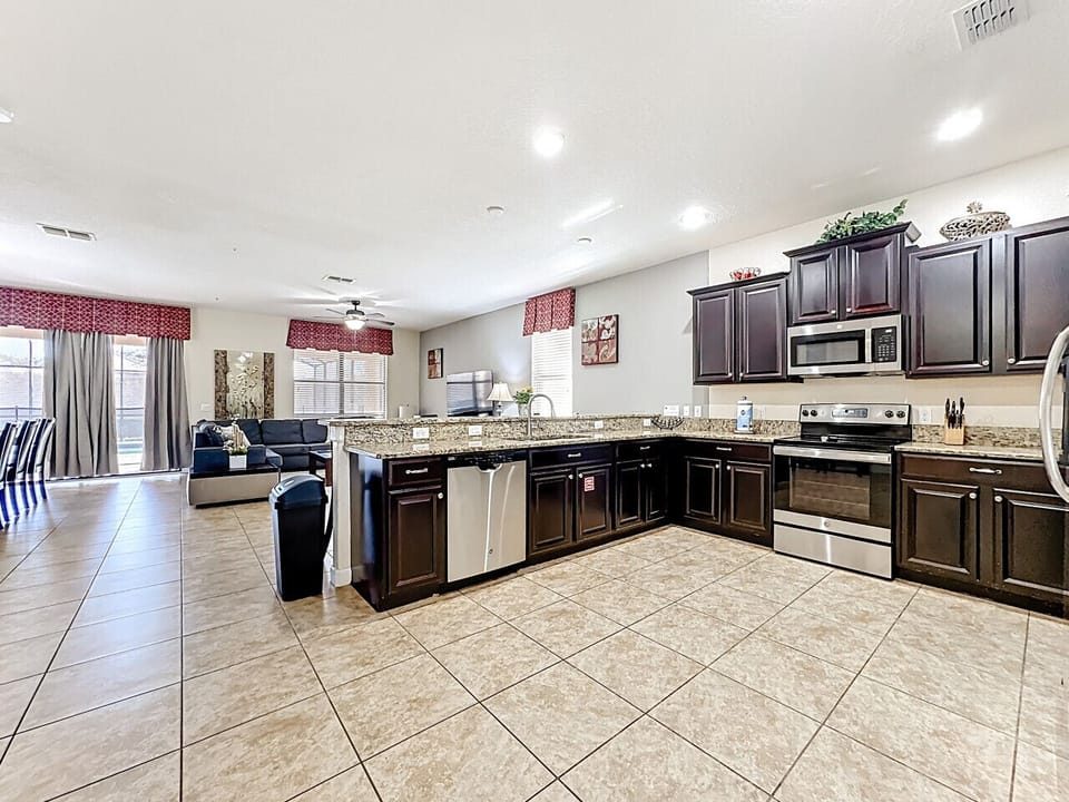 Fully equipped kitchen with modern appliances and a spacious dining area.